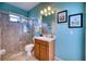 Bathroom with shower, toilet, and vanity with wood cabinets at 9351 Raes Creek Pl, Palmetto, FL 34221