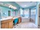 Spa-like bathroom with double vanity, large soaking tub, and walk-in shower at 9351 Raes Creek Pl, Palmetto, FL 34221