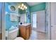 Coastal-styled bathroom with ocean view, vanity, toilet, and walk-in shower at 9351 Raes Creek Pl, Palmetto, FL 34221