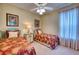 Bedroom with two twin beds, nightstand, and ceiling fan at 9351 Raes Creek Pl, Palmetto, FL 34221