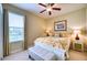 Bright bedroom with a queen bed, neutral carpet, and a window providing plenty of natural light at 9351 Raes Creek Pl, Palmetto, FL 34221
