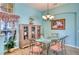 Light and airy dining room with glass table and ornate chairs at 9351 Raes Creek Pl, Palmetto, FL 34221