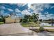 House exterior with driveway, landscaping, and pond view at 9351 Raes Creek Pl, Palmetto, FL 34221