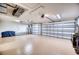 Spacious garage with overhead lighting, multiple garage doors, and ample room for storage and workspace at 9351 Raes Creek Pl, Palmetto, FL 34221