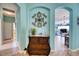 Elegant entryway with decorative wall art and view into living and dining areas at 9351 Raes Creek Pl, Palmetto, FL 34221