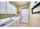 Laundry room with washer, dryer, cabinets, and built-in storage at 9351 Raes Creek Pl, Palmetto, FL 34221