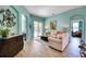 Comfortable living room with light-colored sofa and access to the backyard at 9351 Raes Creek Pl, Palmetto, FL 34221