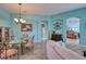 Spacious living room with light walls, tiled floors, and a view to the dining room at 9351 Raes Creek Pl, Palmetto, FL 34221