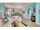 Bright living room featuring hardwood floors, comfortable seating, and access to the outdoor patio at 9351 Raes Creek Pl, Palmetto, FL 34221