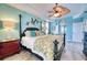 The main bedroom features a spacious layout with a four-poster bed, hardwood floors, and a ceiling fan at 9351 Raes Creek Pl, Palmetto, FL 34221