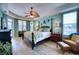 Main bedroom with a king-size bed and large windows at 9351 Raes Creek Pl, Palmetto, FL 34221