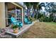 Screened patio with comfortable teal chairs and potted plants at 9351 Raes Creek Pl, Palmetto, FL 34221