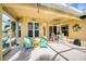 Bright and airy covered patio with seating and outdoor fan at 9351 Raes Creek Pl, Palmetto, FL 34221