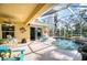 Relaxing pool area with covered patio, seating, and outdoor kitchen at 9351 Raes Creek Pl, Palmetto, FL 34221