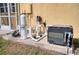 Outdoor pool equipment setup, including a pump and filter system on a concrete pad, is set next to the home's stucco wall at 9351 Raes Creek Pl, Palmetto, FL 34221