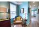 Cozy sitting area with comfortable chair, side table, and ample natural light from the nearby window at 9351 Raes Creek Pl, Palmetto, FL 34221