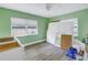 Bedroom with green walls and hardwood floors at 104 23Rd St, Bradenton Beach, FL 34217