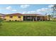 Large backyard showcasing a house with a red tile roof at 1051 N Cypress Point Dr, Venice, FL 34293