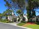 Grand clubhouse entrance with lush landscaping at 10828 Trophy Dr, Englewood, FL 34223