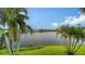 Backyard oasis with lush landscaping, showcasing a serene lake view at 119 Tidewater Dr # 119, Bradenton, FL 34210