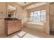 Elegant bathroom with soaking tub, double vanity, and large mirror at 1397 Harbor Dr, Sarasota, FL 34239