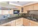 Light wood cabinets, granite countertops, and built-in microwave at 1397 Harbor Dr, Sarasota, FL 34239
