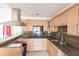 Kitchen with light wood cabinets, granite countertops, and a breakfast bar at 1397 Harbor Dr, Sarasota, FL 34239