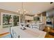 Kitchen dining area with chandelier and view to backyard at 14018 Pine Woods E Ln, Sarasota, FL 34240