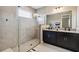 Modern bathroom with double vanity, granite countertop, and large shower at 16714 Savory Mist Cir, Bradenton, FL 34211