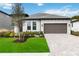 Single-story house with a two-car garage and well-manicured lawn at 16714 Savory Mist Cir, Bradenton, FL 34211