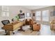 Bright home office with a large desk, comfortable seating, and bookshelves at 16714 Savory Mist Cir, Bradenton, FL 34211
