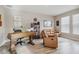 Home office with wooden desk, leather chairs, and built-in shelves at 16714 Savory Mist Cir, Bradenton, FL 34211