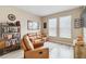 Spacious home office with leather seating and ample natural light at 16714 Savory Mist Cir, Bradenton, FL 34211