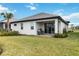 Back of the house showcasing a patio, landscaping, and a large yard at 16714 Savory Mist Cir, Bradenton, FL 34211