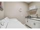 Laundry room with washer, dryer, utility sink, and shelving at 16714 Savory Mist Cir, Bradenton, FL 34211