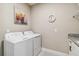 Bright laundry room, featuring washer, dryer, and cabinets at 16714 Savory Mist Cir, Bradenton, FL 34211