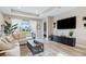 Spacious living room with sectional sofa, large TV, and access to backyard at 16714 Savory Mist Cir, Bradenton, FL 34211
