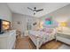 Spacious bedroom with a floral comforter and plenty of natural light at 1724 Hyssop Loop, North Port, FL 34289