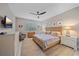 Main bedroom with king-size bed, ceiling fan, and light-colored dresser at 1724 Hyssop Loop, North Port, FL 34289