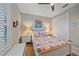Charming bedroom with a floral comforter and plantation shutters at 1724 Hyssop Loop, North Port, FL 34289