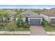 Single-story home with gray roof, gray garage door, and landscaped front yard at 1724 Hyssop Loop, North Port, FL 34289
