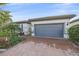 Attractive single-Gathering home with a gray garage door and well-maintained landscaping at 1724 Hyssop Loop, North Port, FL 34289