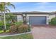 Attractive single-Gathering home with a gray garage door and well-maintained landscaping at 1724 Hyssop Loop, North Port, FL 34289