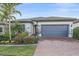 Attractive single-Gathering home with a gray garage door and well-maintained landscaping at 1724 Hyssop Loop, North Port, FL 34289