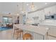 Modern kitchen with white cabinets, quartz countertops and island with seating at 1724 Hyssop Loop, North Port, FL 34289