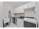 Bright laundry room with washer, dryer, and cabinets at 1724 Hyssop Loop, North Port, FL 34289