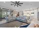 Living room with patterned sofas, ceiling fan, and access to lanai at 1724 Hyssop Loop, North Port, FL 34289
