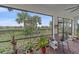 Peaceful screened porch with seating and lush landscaping at 1724 Hyssop Loop, North Port, FL 34289