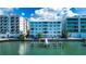 Waterfront building with private dock and partial sunset view at 174 Golden Gate Pt # 21, Sarasota, FL 34236