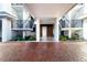 Modern building entrance with brick pavers and landscaped areas at 174 Golden Gate Pt # 21, Sarasota, FL 34236